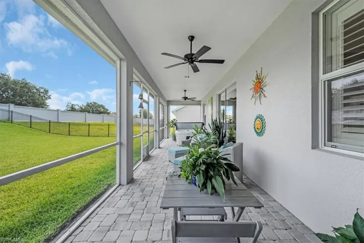 Sunroom / solarium featuring ceiling fan