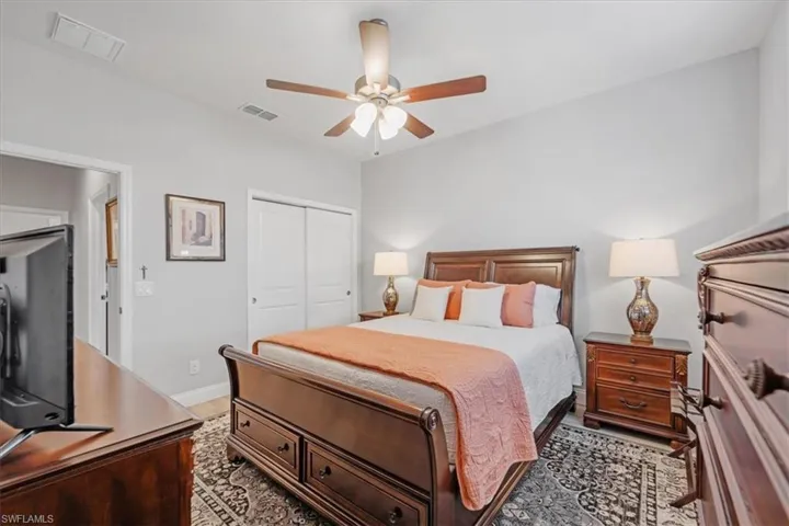 Bedroom with ceiling fan, a closet, and light hardwood / wood-style floors