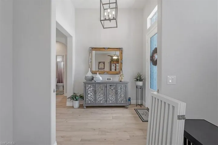 Entrance foyer featuring an inviting chandelier and hardwood / wood-style floors