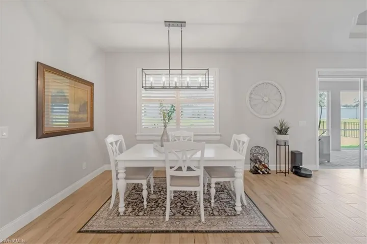 Dining area with an inviting chandelier and wood-type flooring