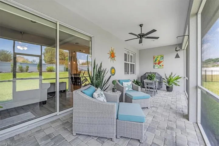Sunroom featuring plenty of natural light and ceiling fan