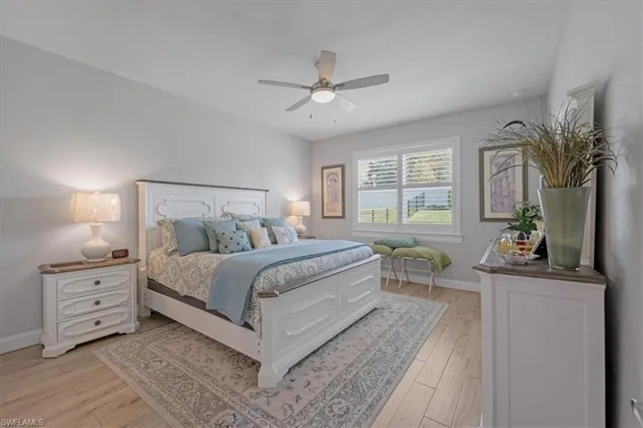 Bedroom with ceiling fan and light hardwood / wood-style flooring