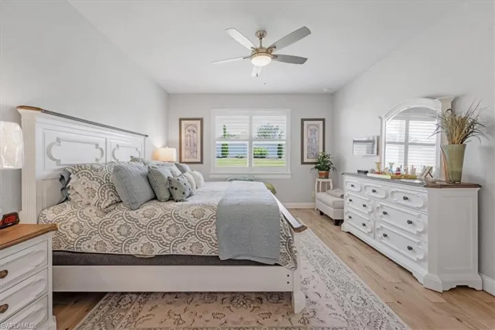 Bedroom with ceiling fan and light hardwood / wood-style flooring