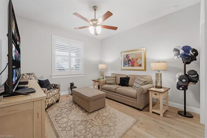Living room featuring ceiling fan and light wood-type flooring