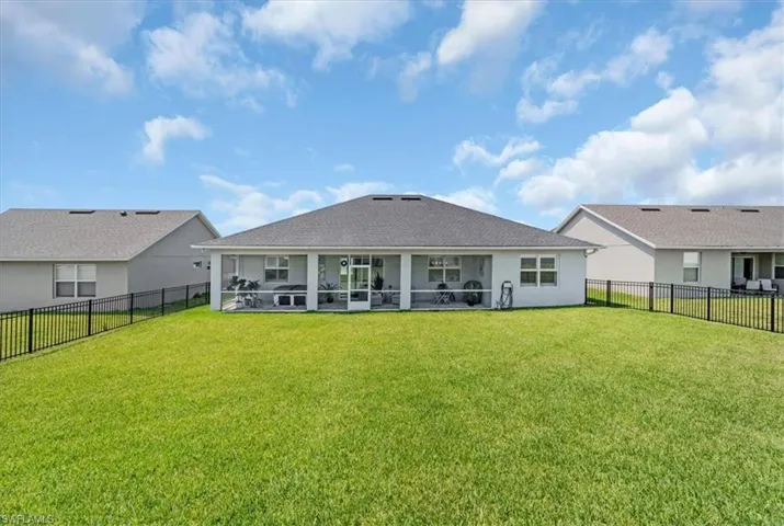 Back of property featuring a lawn