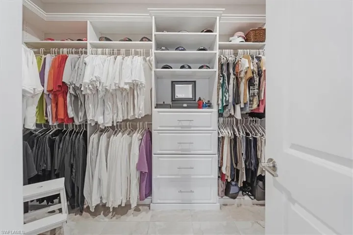 Walk in closet featuring light tile flooring