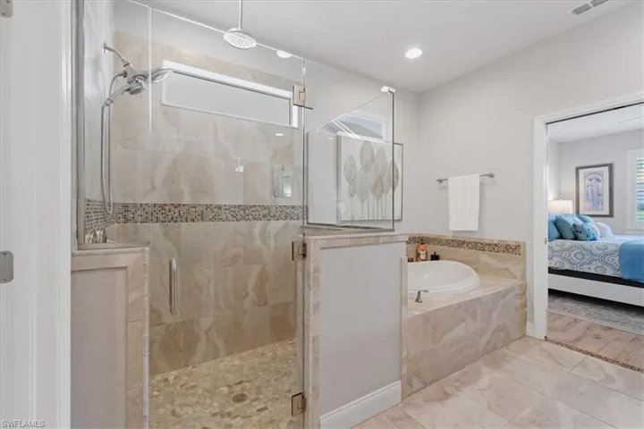 Bathroom with walk in shower and tile flooring