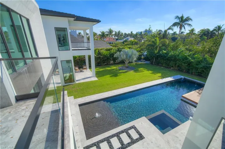 View of swimming pool with a patio area, a jacuzzi, and a yard