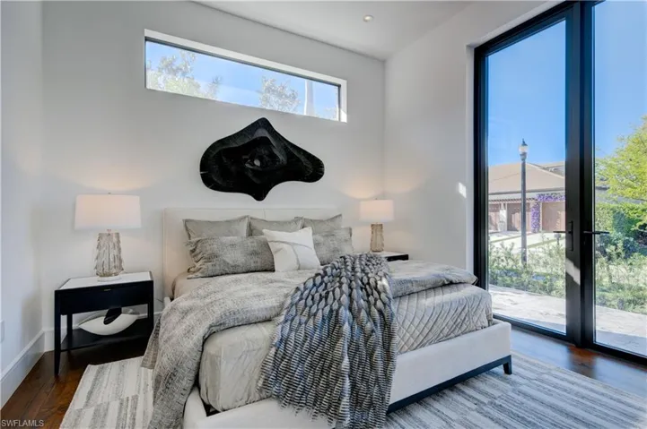 Bedroom featuring hardwood / wood-style floors and access to exterior