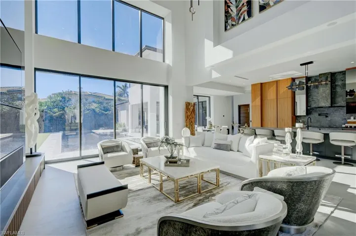 Living room featuring a mountain view, a healthy amount of sunlight, and a high ceiling