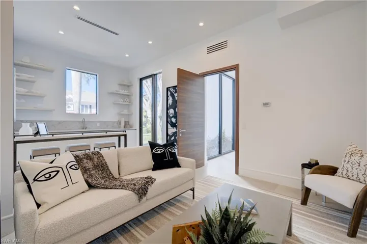 Living room with light hardwood / wood-style floors and sink