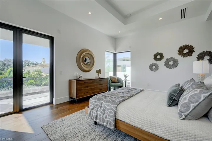 Bedroom featuring access to exterior and wood-type flooring