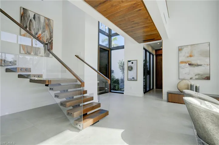 Foyer featuring wood ceiling and a high ceiling