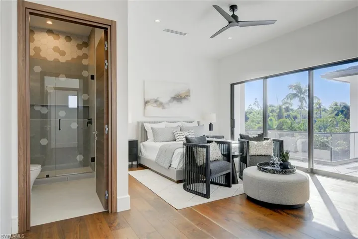 Bedroom with access to outside, ceiling fan, light hardwood / wood-style flooring, and ensuite bathroom
