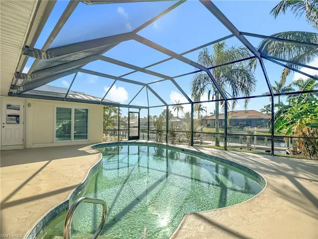 Outdoor pool with a lanai, a sunroom, and a patio