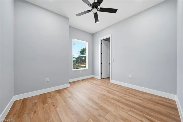 Empty room featuring light wood-type flooring and ceiling fan