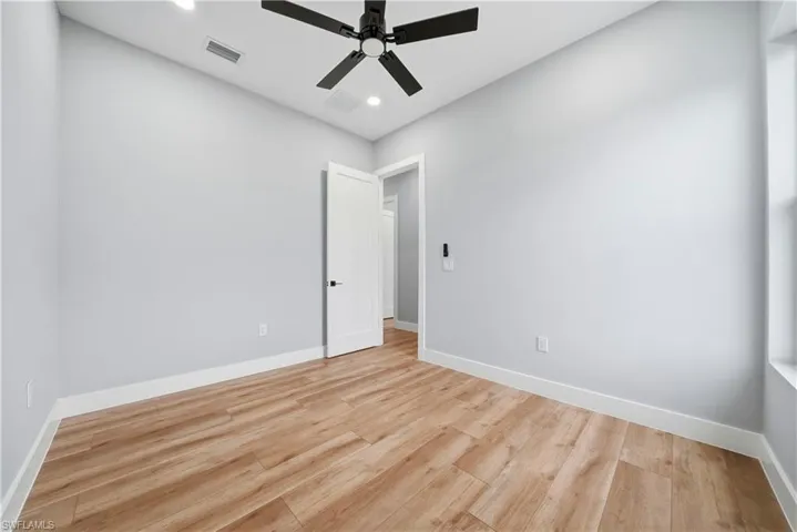 Unfurnished room with light wood finished floors, a ceiling fan, and recessed lighting