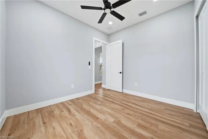 Unfurnished bedroom with light wood-style floors, a ceiling fan, recessed lighting, and a closet