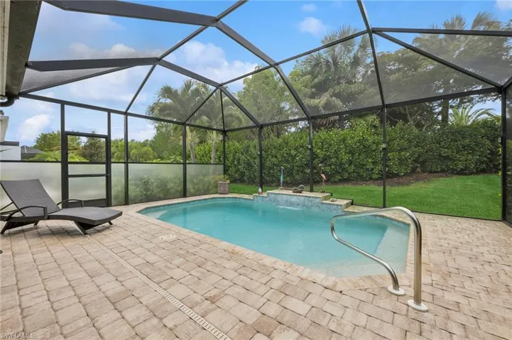 Saltwater heated swimming pool is West facing with screen enclosure,  patio, and privacy