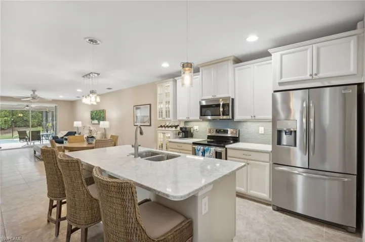 Quartz counters, sea glass backsplash and added pendent lighting.