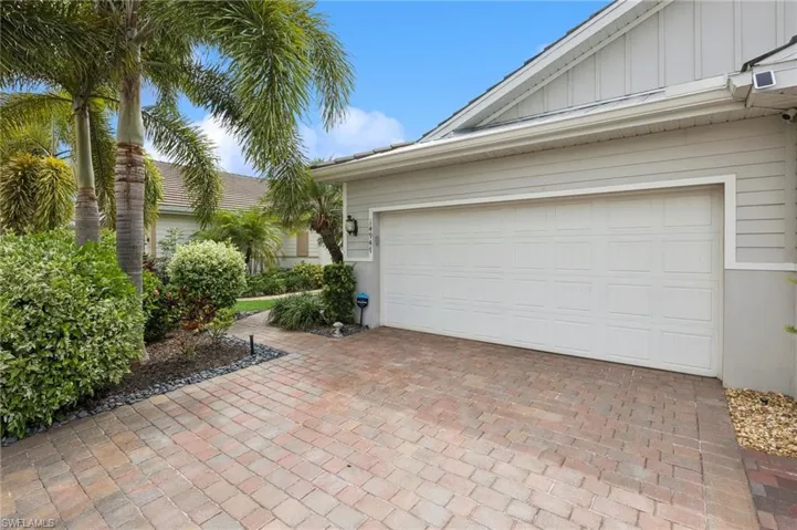 Paved driveway and walkway enhanced with beautiful landscaping.