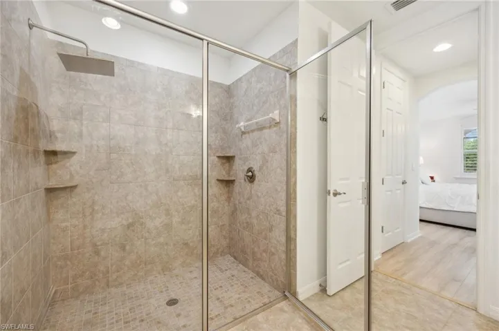 Bathroom featuring an enclosed shower and hardwood / wood-style flooring