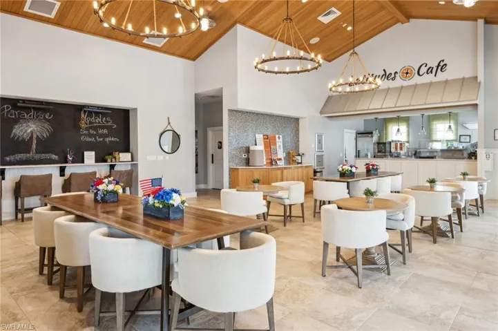 Tiled dining area featuring beamed ceiling, a notable chandelier, high vaulted ceiling, and wood ceiling