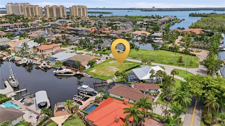 Waterfront lot with direct Gulf access, mature landscaping, and surrounding canals