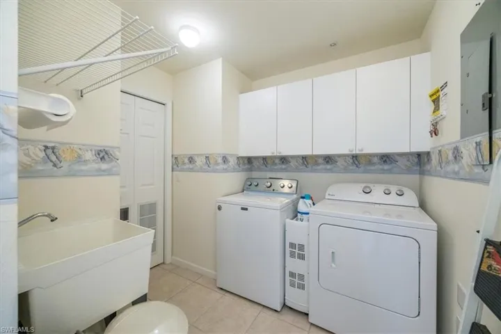 Spacious laundry room with utility sink