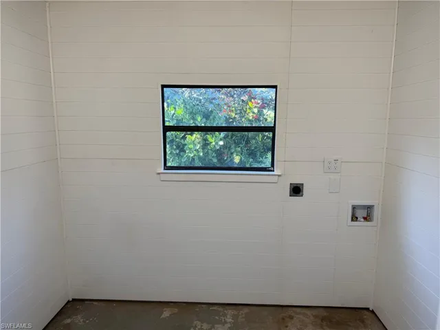 Laundry room outside with hookup for washer and dryer and storage