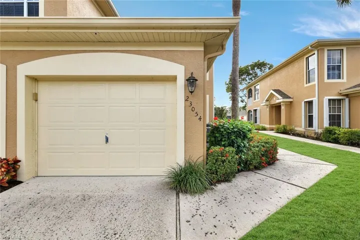 Garage featuring concrete driveway
