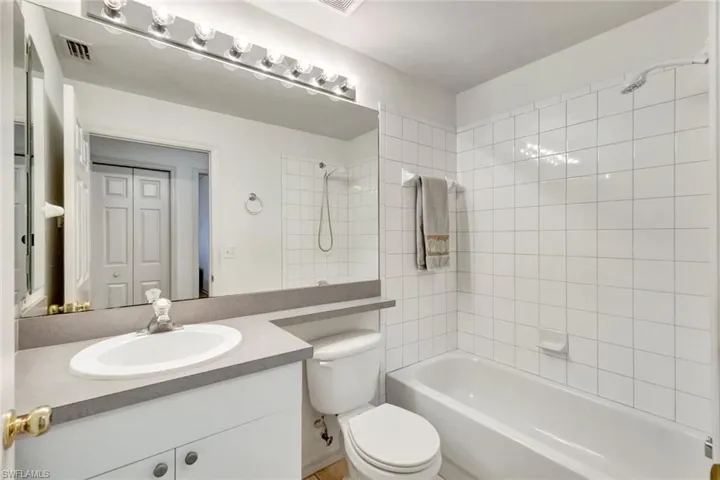Full bathroom featuring visible vents, shower / bath combination, vanity, and toilet