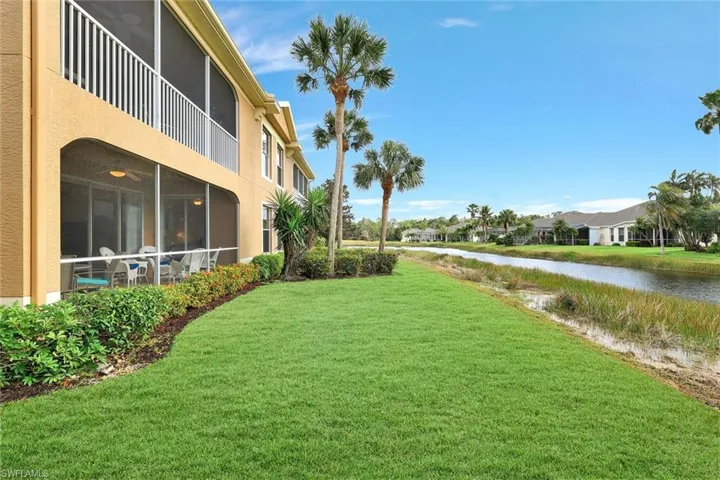 View of yard with a Lanai and a water view