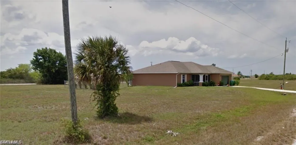 Single story home with a front lawn