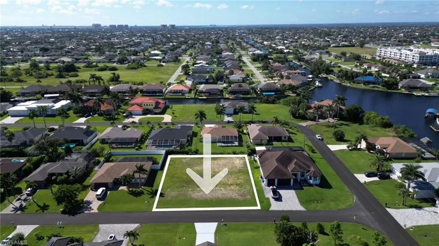 Aerial overview of property's location featuring a large body of water and property boundaries highlighted