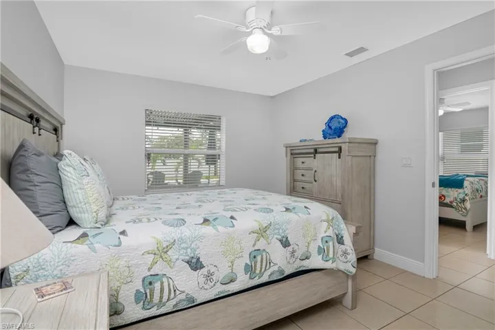 Bedroom featuring light tile patterned floors and ceiling fan