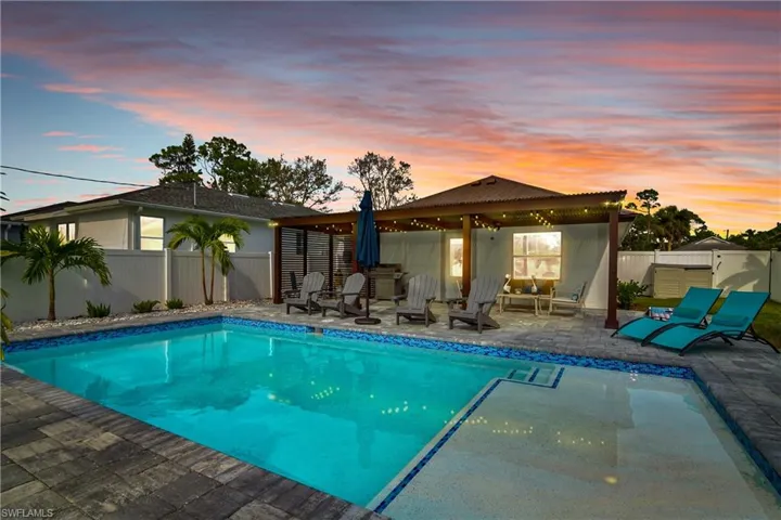 Pool at dusk with a patio area