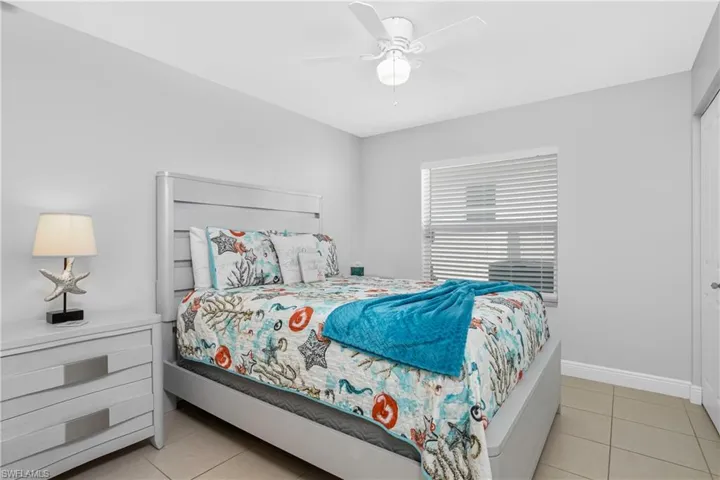 Tiled bedroom with ceiling fan
