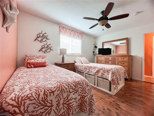 Bedroom with ceiling fan and dark hardwood / wood-style flooring