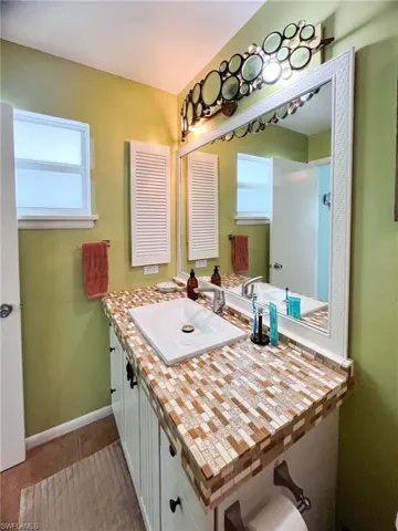 Bathroom with tile patterned floors and vanity