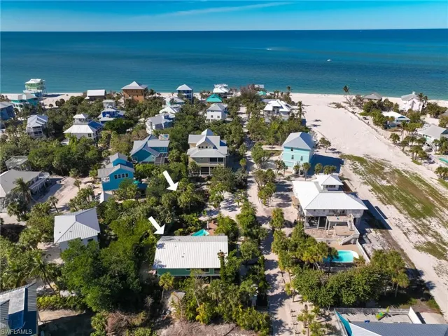 Birds eye view of property with a water view
