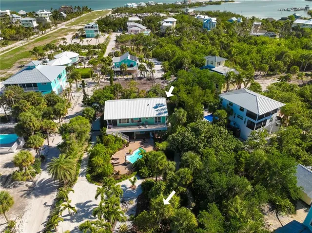Birds eye view of property with a water view
