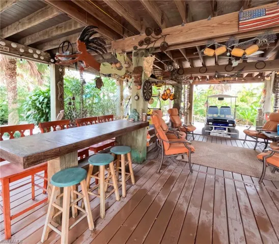Wooden terrace featuring exterior bar
