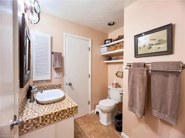 Bathroom with tile patterned floors, vanity, and toilet