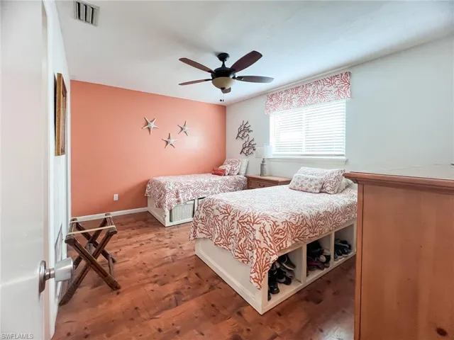 Bedroom featuring ceiling fan and wood-type flooring