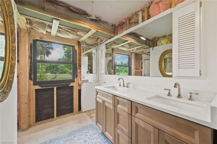 Bathroom featuring double vanity and concrete flooring