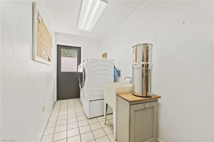 Laundry room featuring washer / clothes dryer and light tile patterned floors