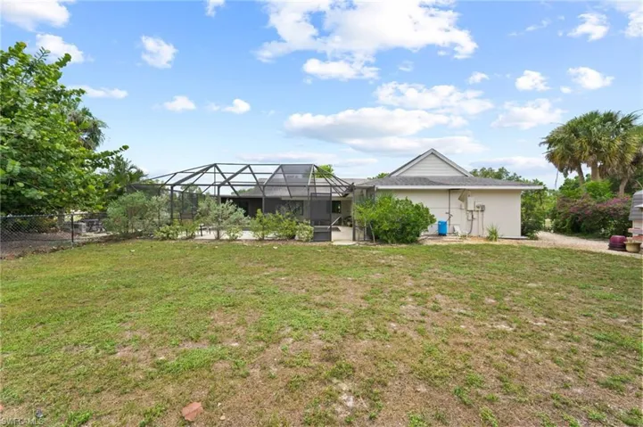 View of yard featuring glass enclosure