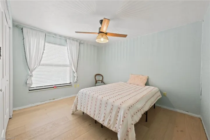 Bedroom featuring wood finished floors and a ceiling fan