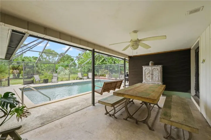 Outdoor pool featuring a patio, ceiling fan, and a lanai